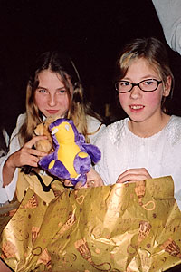 Children unwrap their Christmas gifts