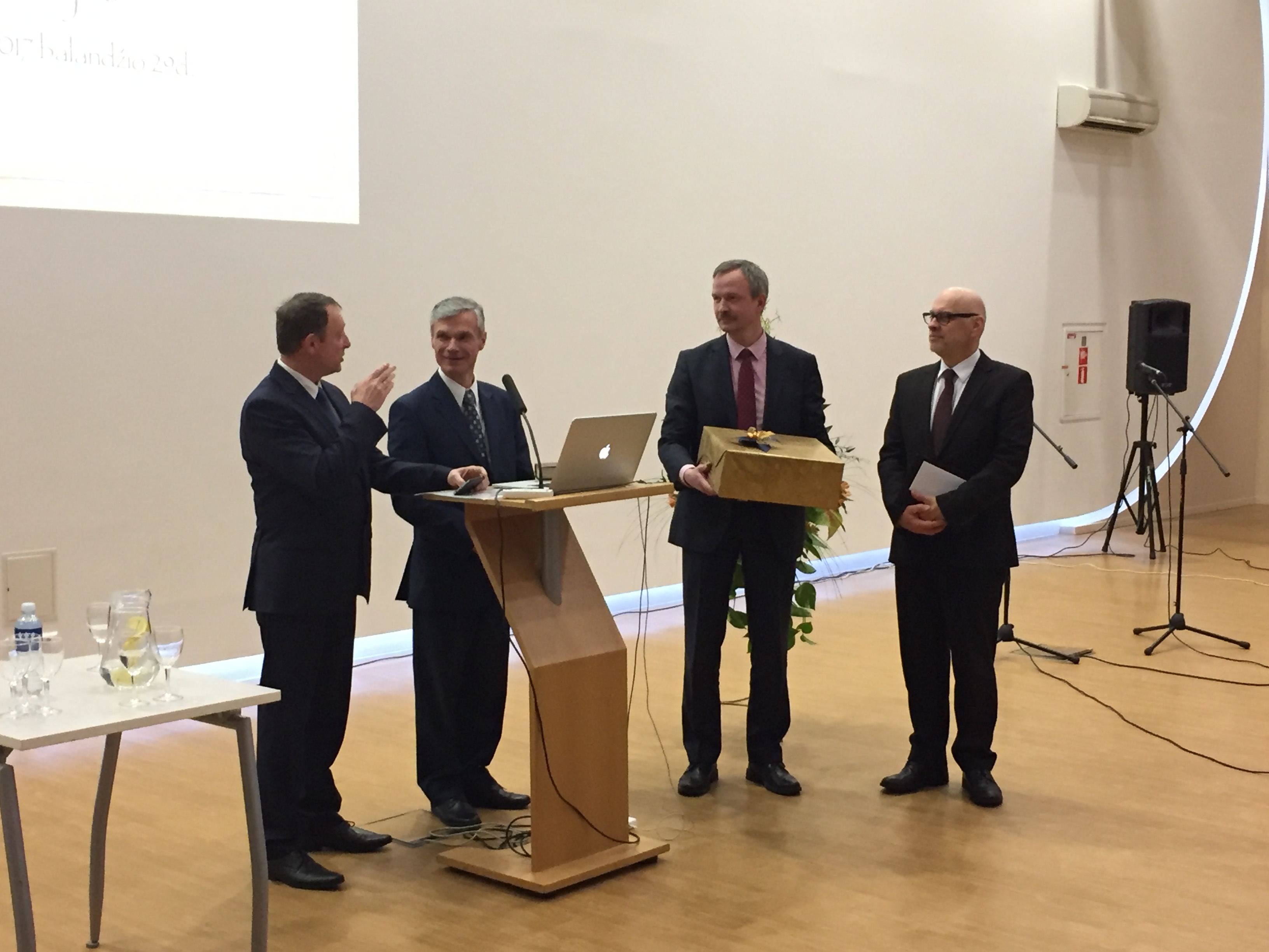 David Nõmmik (left) presents a gift on behalf of the Baltic Union and Estonian and Latvian Conferences